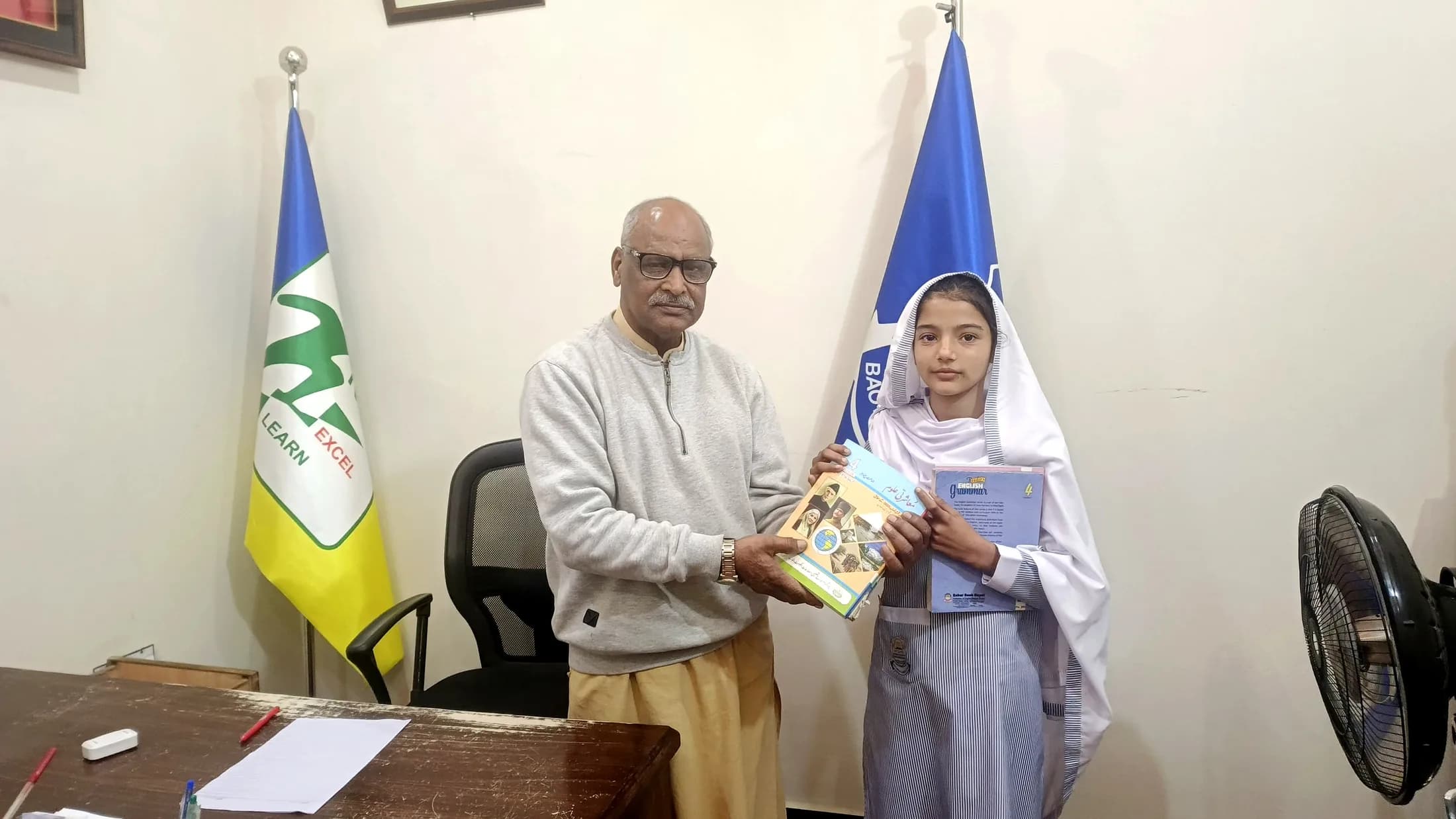 A student receiving school books