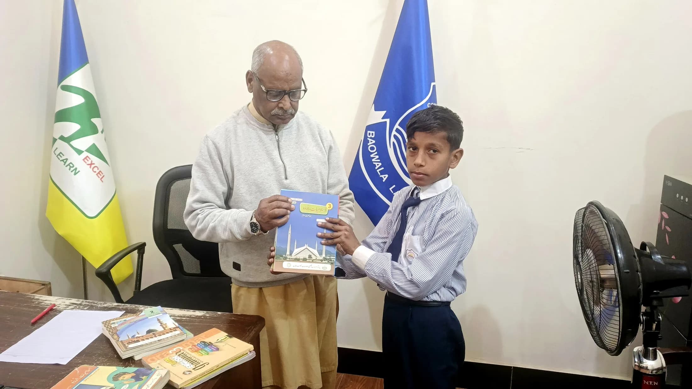 A student receiving school books